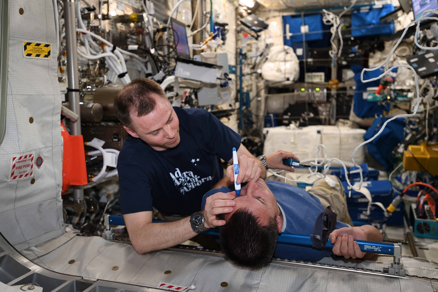 astronaut Nick Hague collecting intraocular pressure measurements