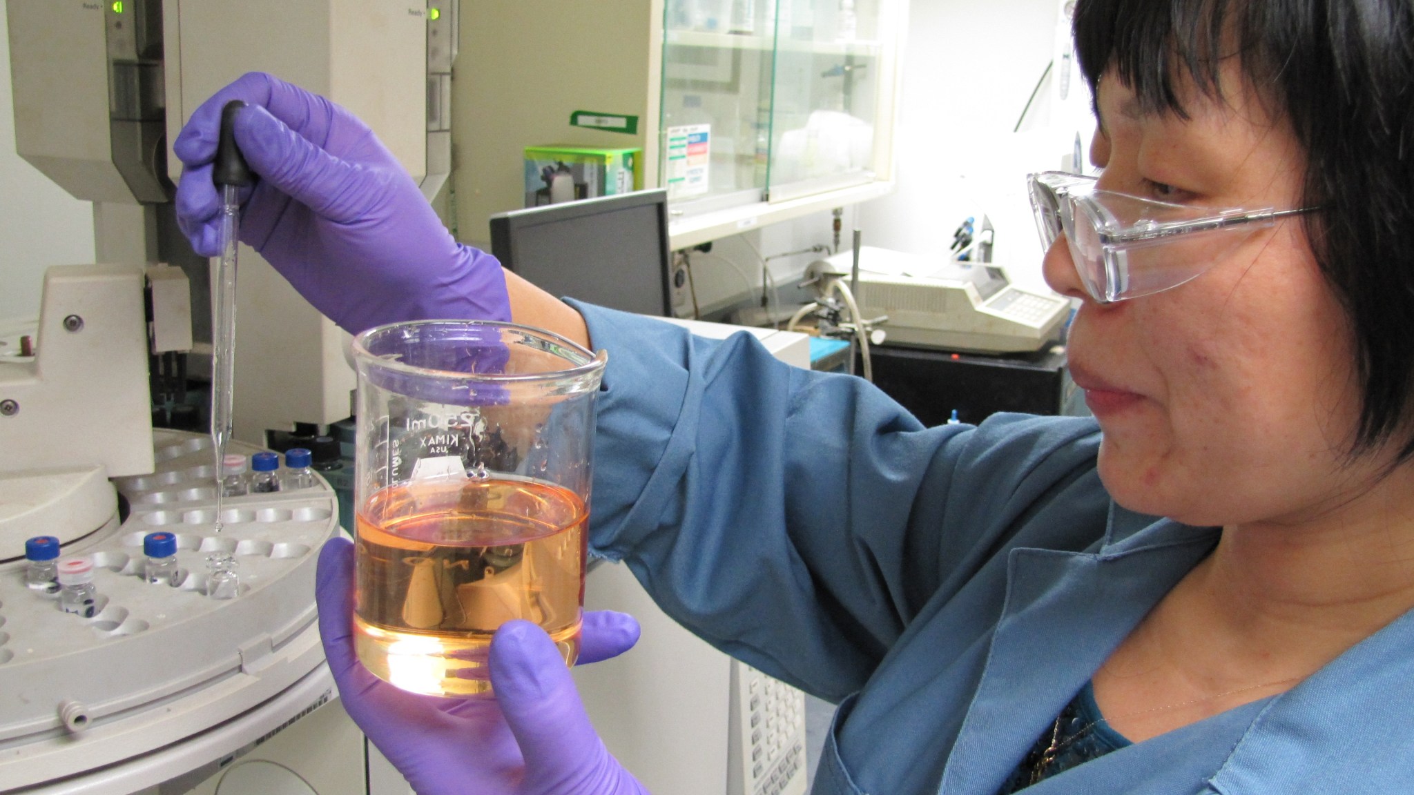 An Aerojet Rocketdyne researcher examines a container of the Advanced Spacecraft Energetic Non-Toxic (ASCENT) 