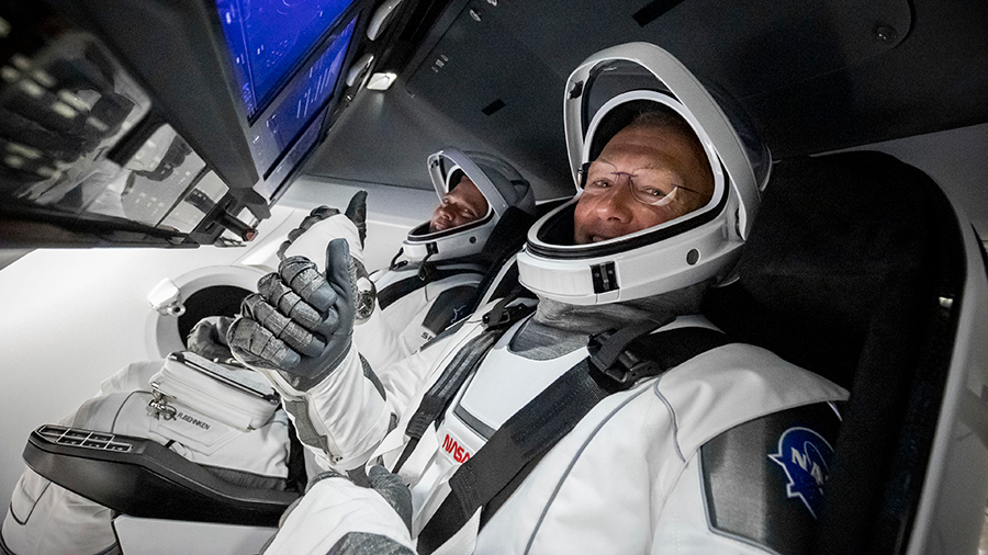 NASA's first commercial crew astronauts (front to back) Doug Hurley and Bob Behnken are pictured in January during tests inside the SpaceX Crew Dragon vehicle. Credit: SpaceX