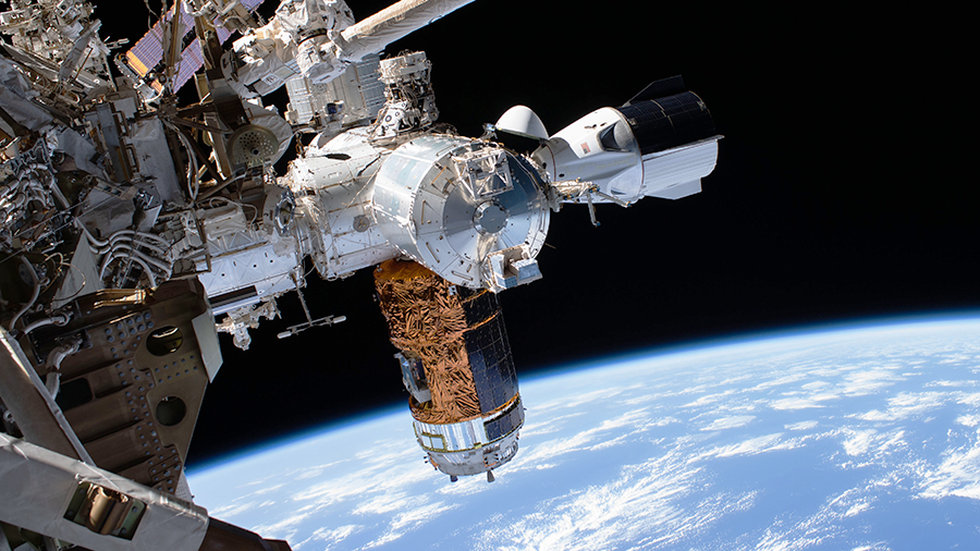 The SpaceX Crew Dragon and the Japan's HTV-9 resupply ship figure prominently in this photograph taken during the July 1 spacewalk.