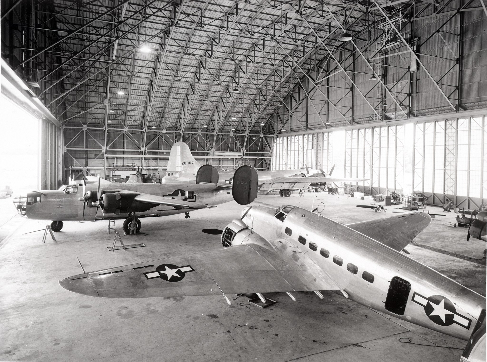 Several World War II-era aircraft inside the hangar in 1944