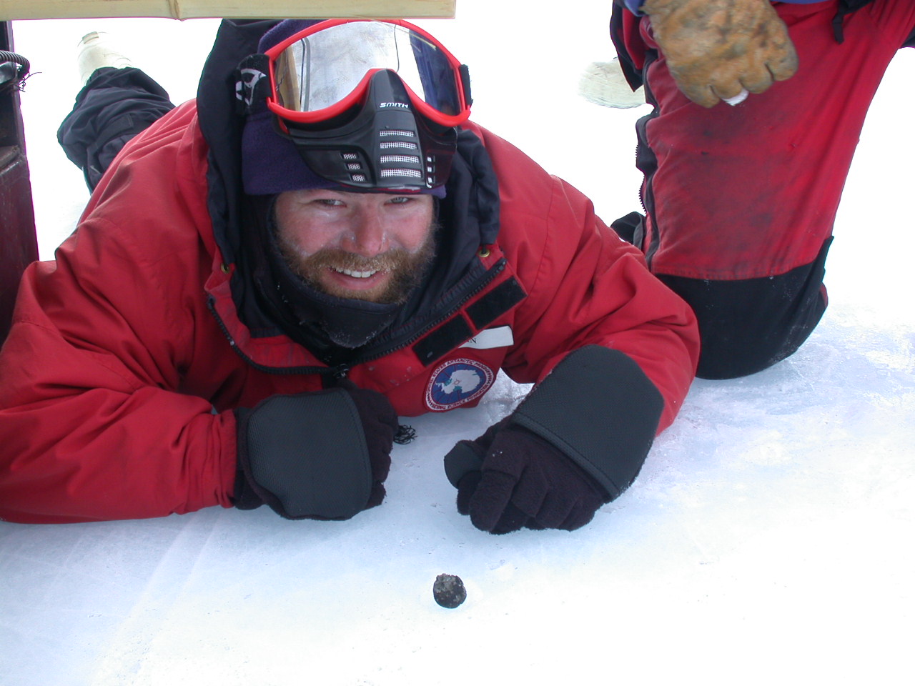 Astrobiologist Daniel Glavin poses with meteorite