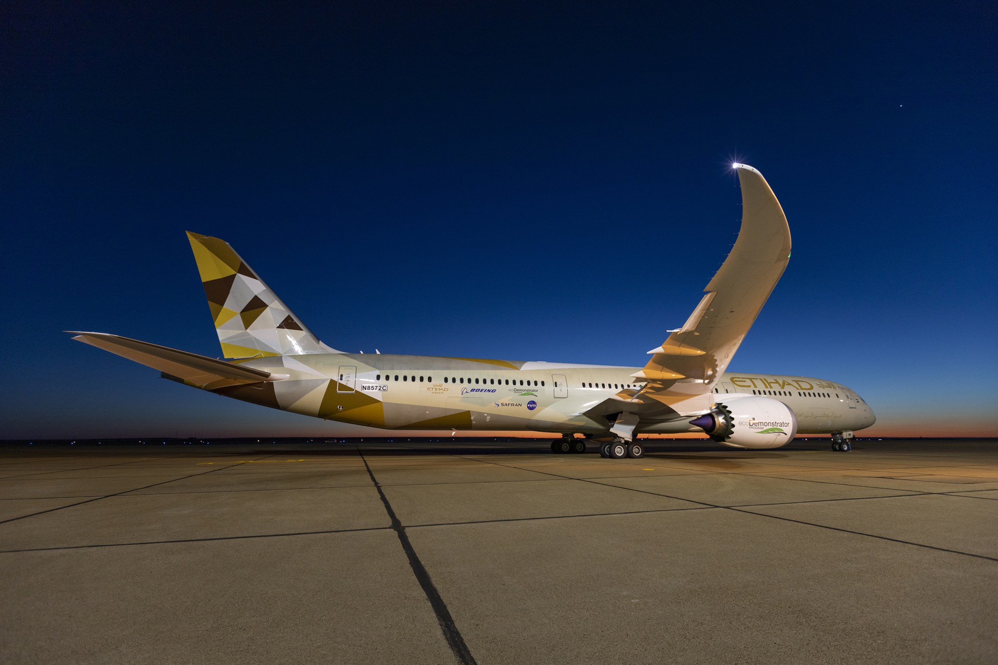 The 787-10 Dreamliner parked on the tarmac at sunset.