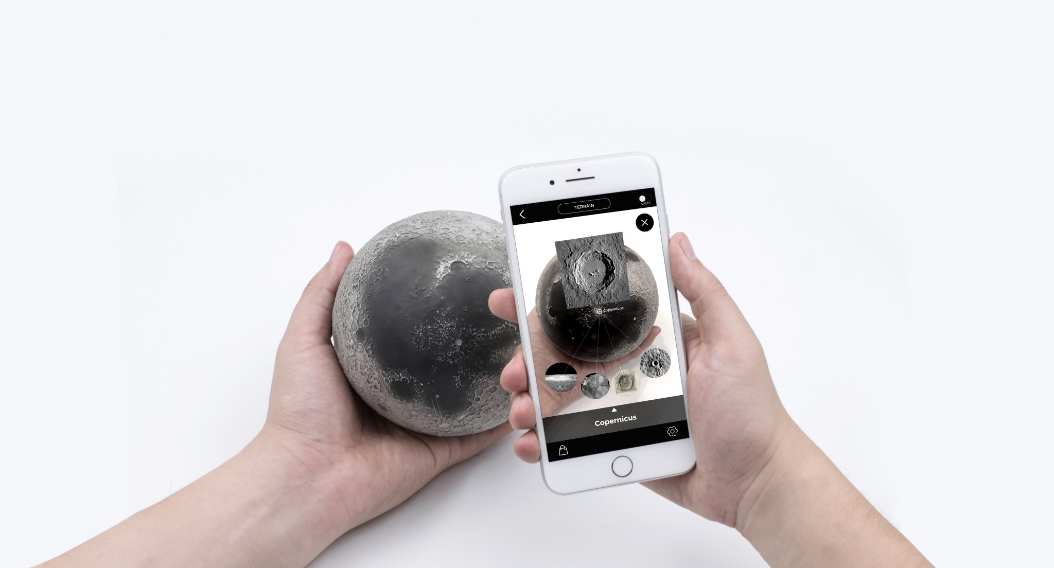 Person holding Astro Reality Moon model