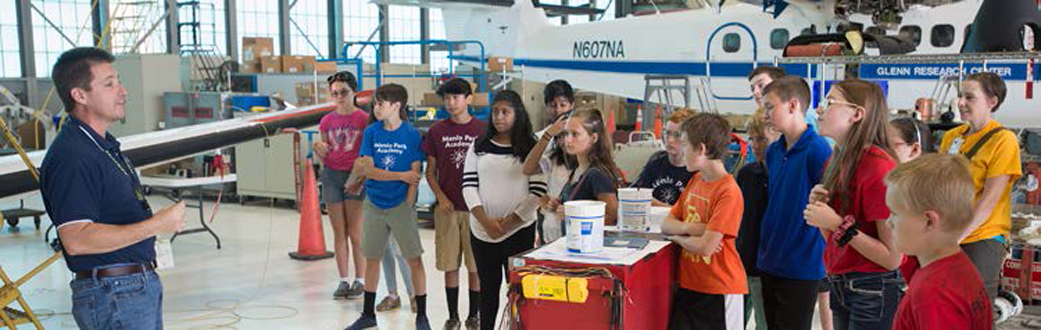 NASA Glenn pilot Jim Demers conducting a Flight Research Facility tour with students during Aviation Day 2017