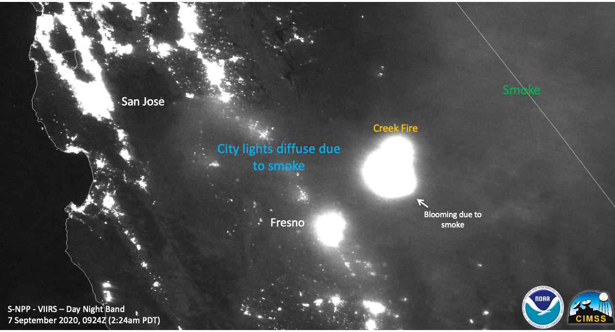 Suomi NPP image of Creek Fire at night in California. The image is black and white with smoke and city lights in white. The cities San Jose and Fresno are labeled. The NOAA and CIMSS logos are in the bottom right corner. "S-NPP - VIIRS - Day Night Band 7 September 2020, 0924Z (2:24am PDT)" is in the left bottom corner. The creek fire is labeled east of Fresno. City lights diffuse due to smoke and smoke are also labeled. 