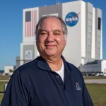 Kennedy Space Center's Jose Perez Morales is photographed with the Vehicle Assembly Building in the background.