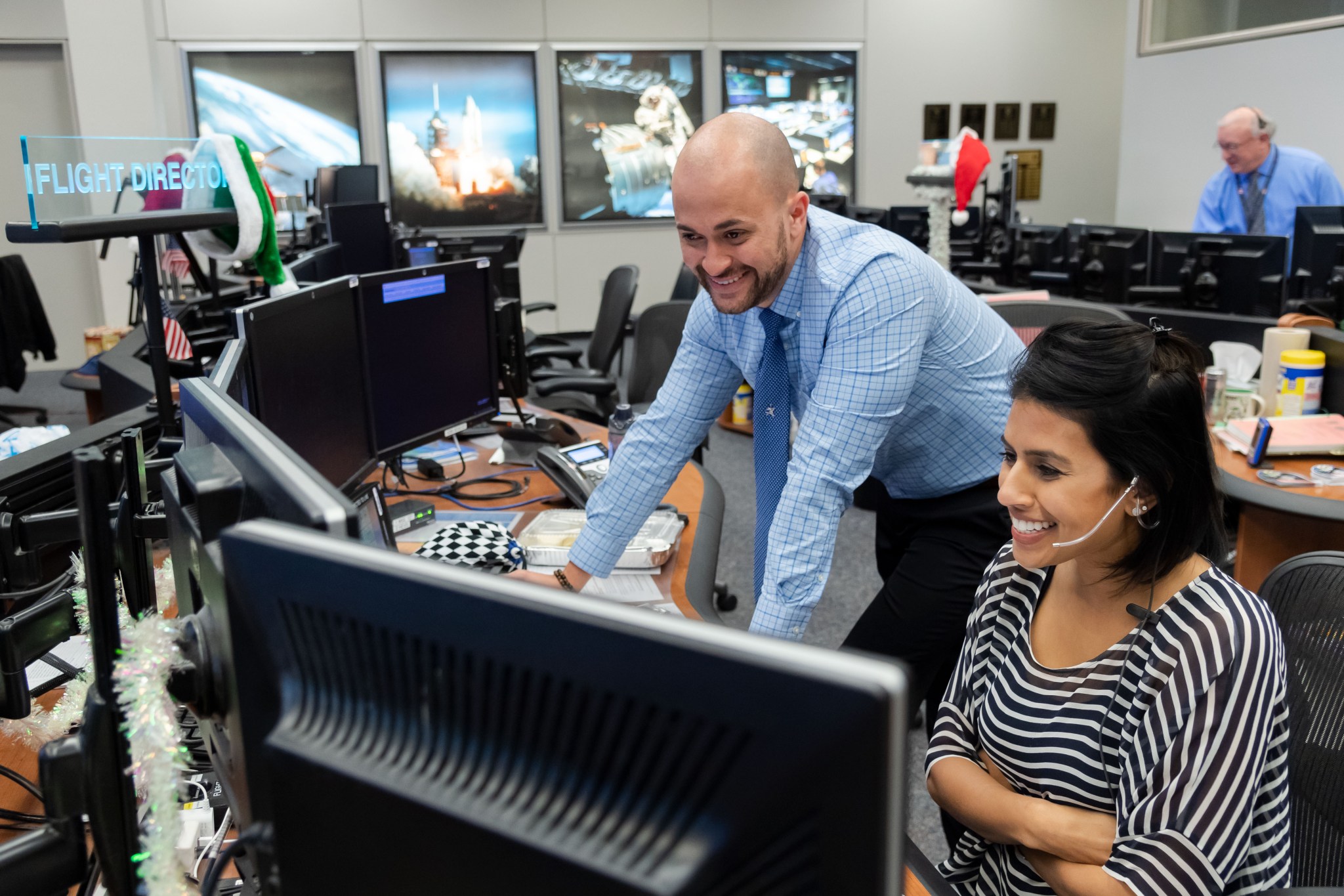 Expedition 61 Flight Directors Marcos Flores and Pooja Jesrani along with their team of flight controllers monitor operations