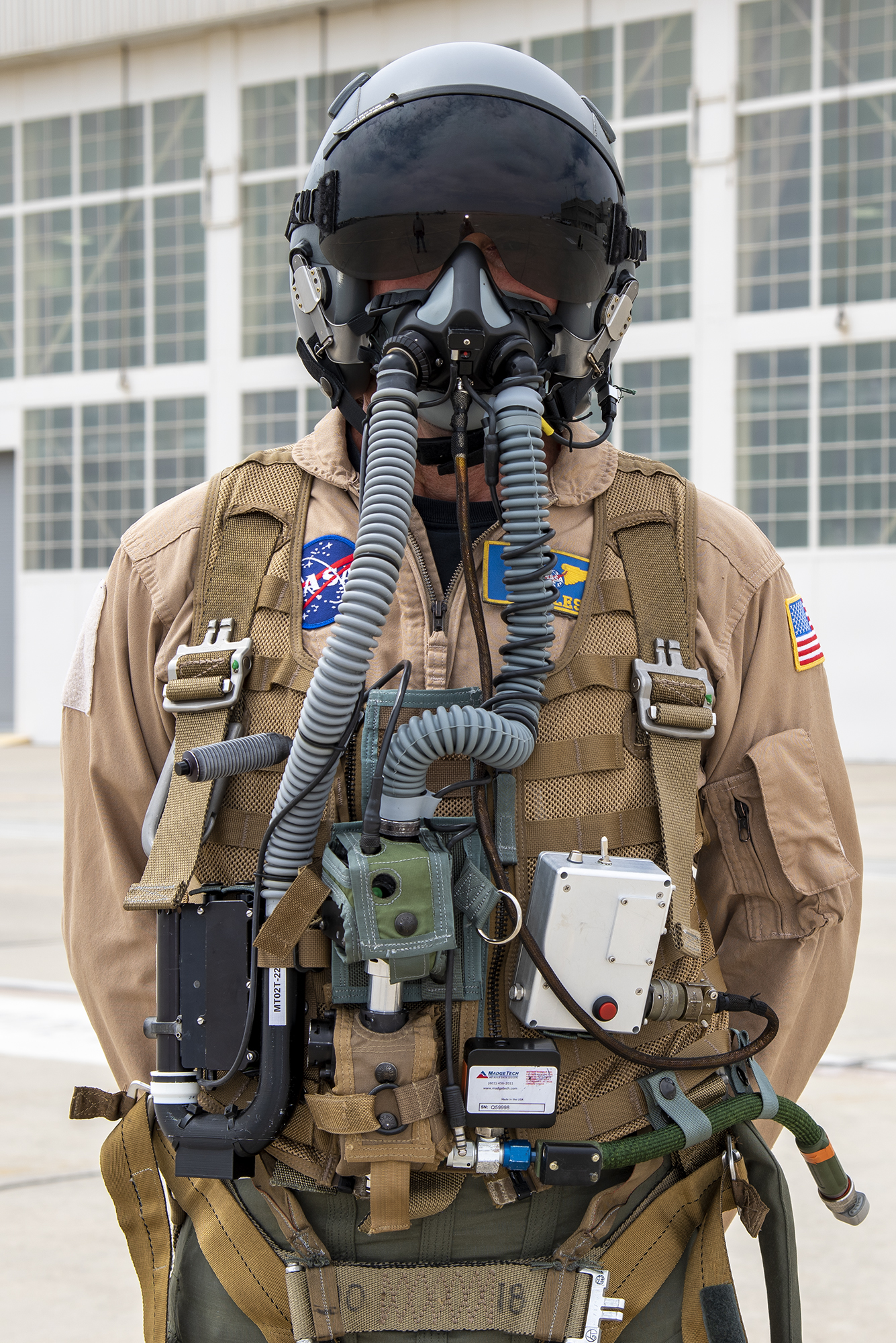 NASA research pilot Jim Less wears a U.S. Navy harness configuration of JPL prototype mask.