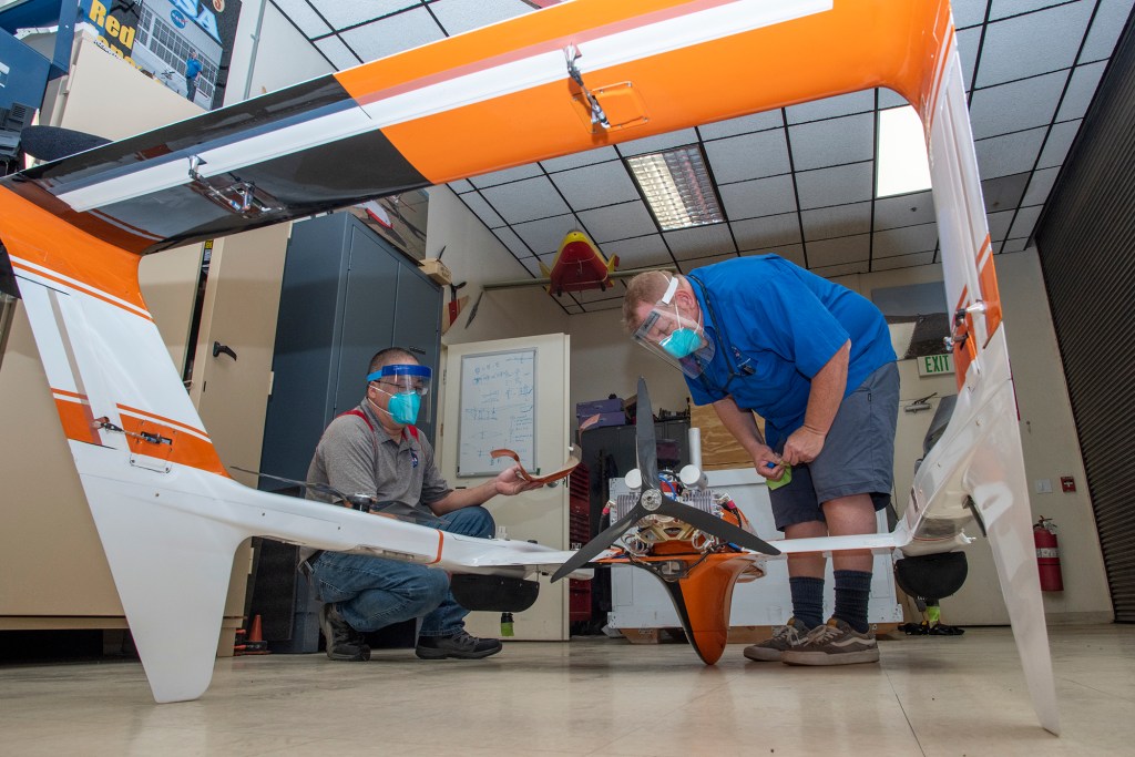 Derek Abramson and Robert Jensen assemble pieces of the HQ-90.
