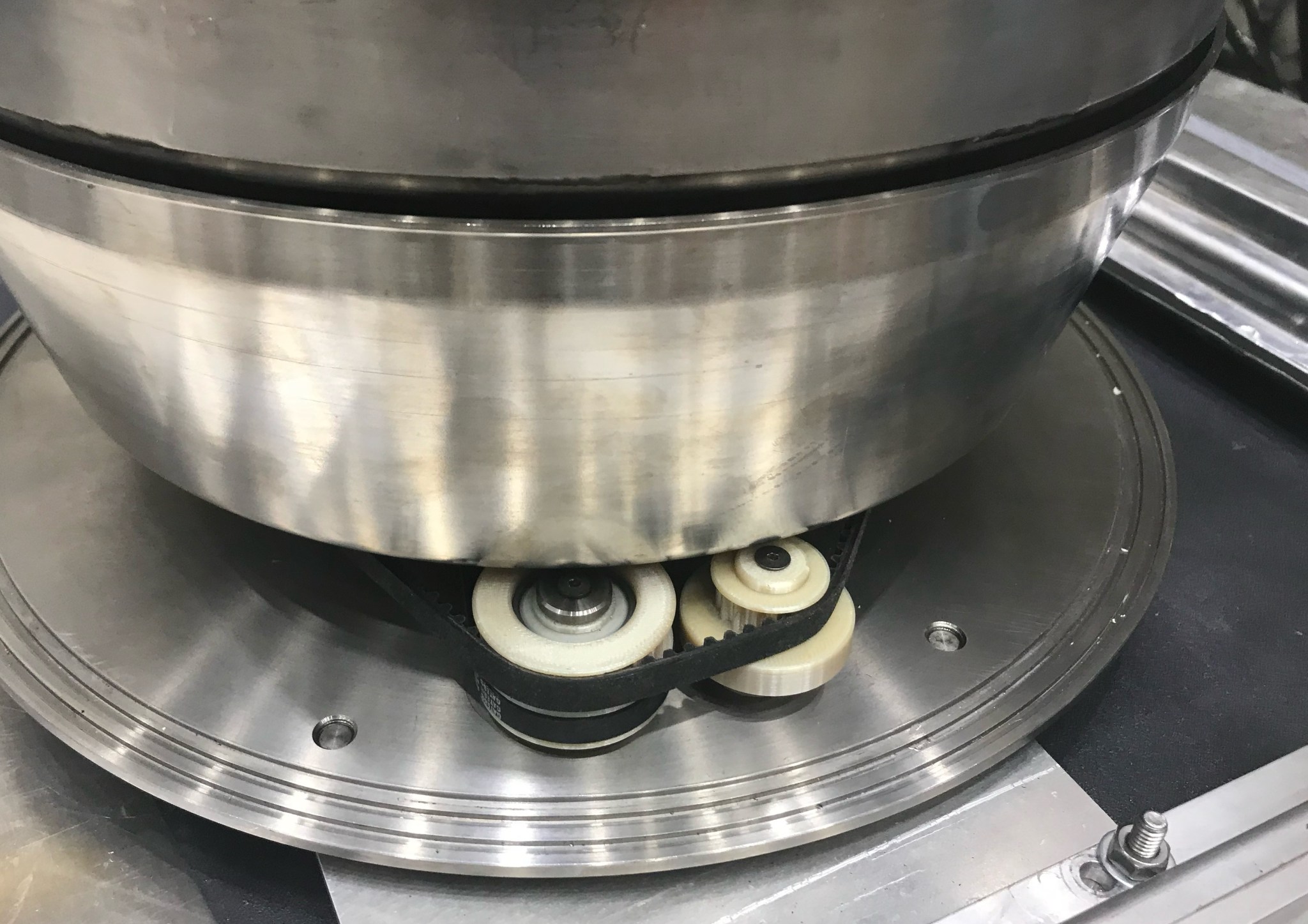 The newly redesigned and 3D-printed plastic pulley undergoes testing.