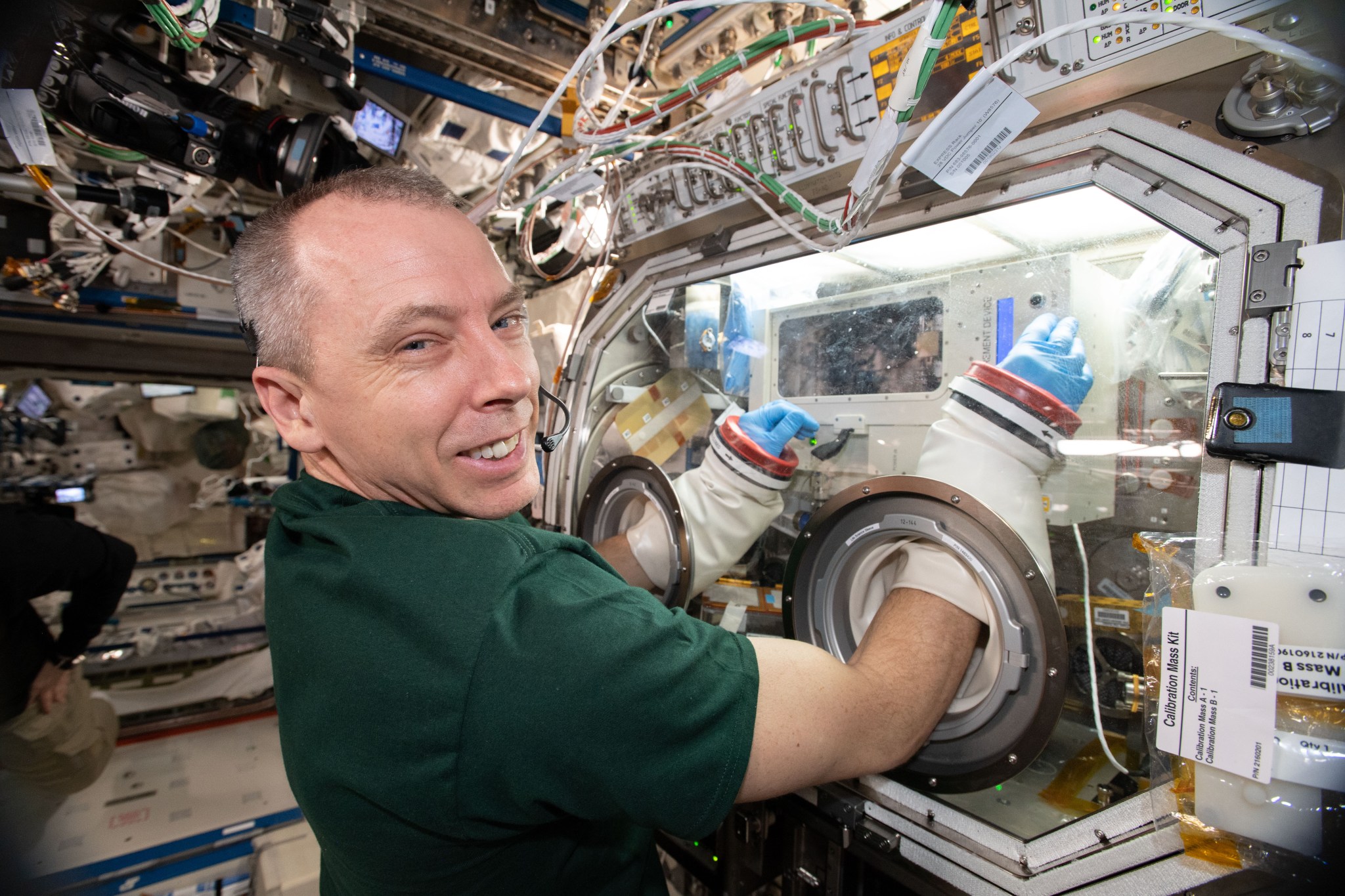 NASA astronaut Andrew Feustel works inside the Microgravity Science Glovebox aboard the International Space Station.