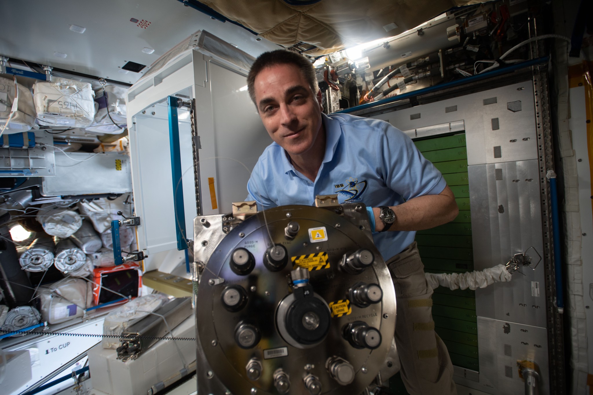 Expedition 63 Commander Chris Cassidy installs the new Urine Processing Assembly’s distillation assembly in Node 3. 