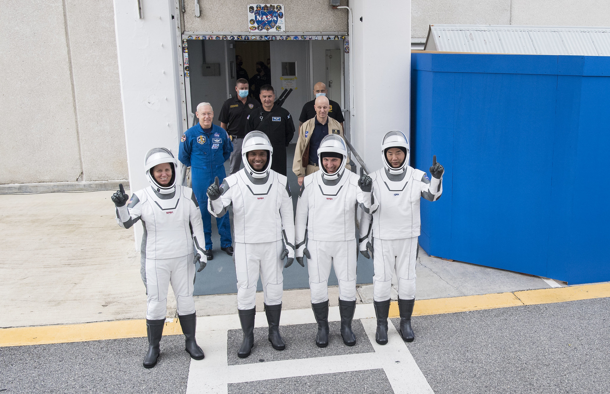 NASA astronauts Shannon Walker, left, Victor Glover, and Mike Hopkins, and JAXA astronaut Soichi Noguchi, right