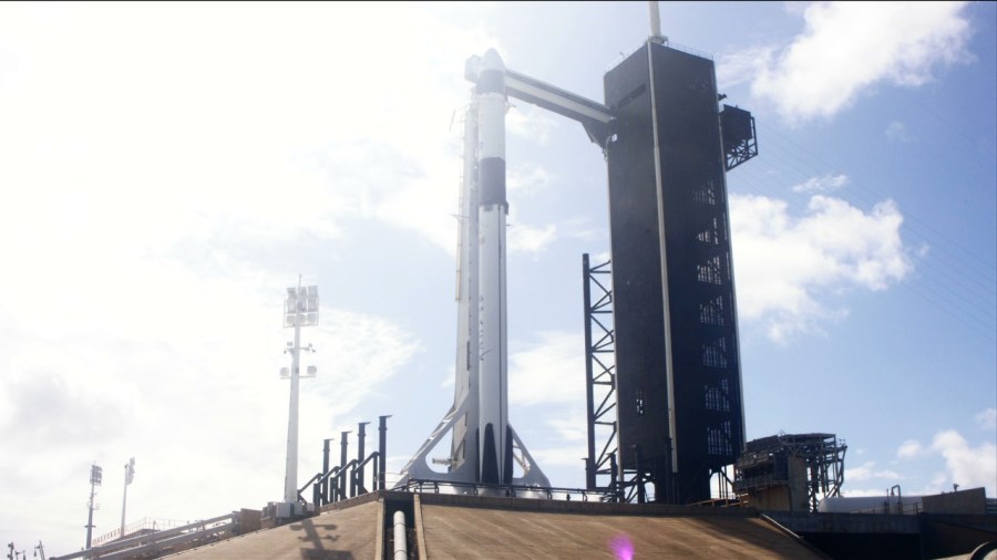 The SpaceX Falcon 9 rocket and Crew Dragon spacecraft stand on the launch pad at Kennedy Space Center's Launch Complex 39A.