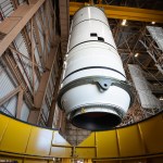 Technicians lift the right aft motor segment – one of five segments that make up one of two solid rocket boosters for the agency