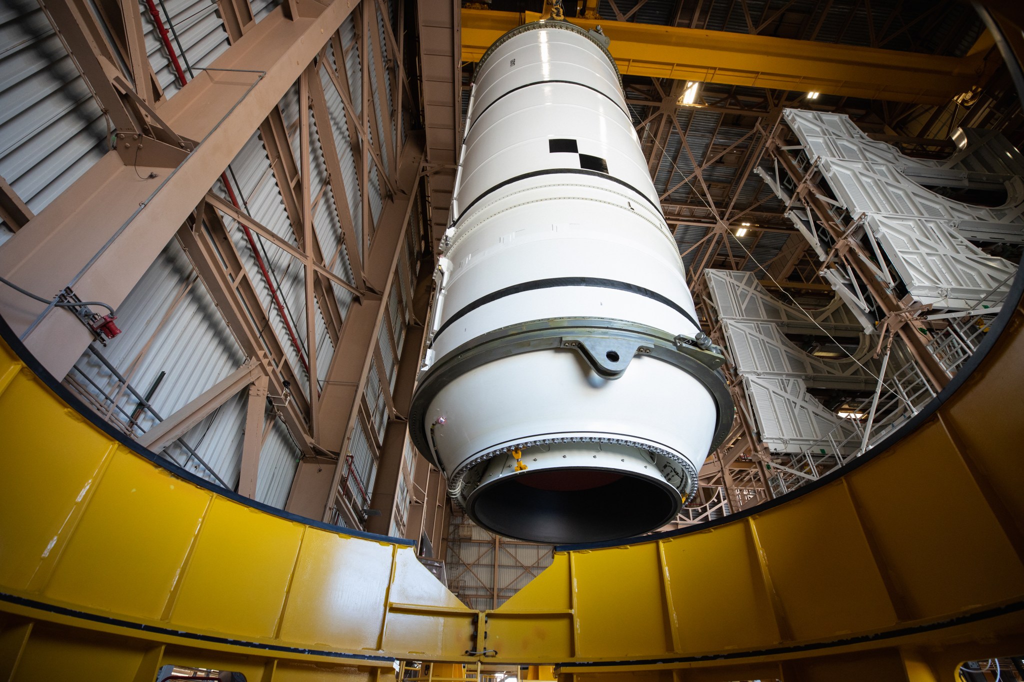 Technicians lift the right aft motor segment – one of five segments that make up one of two solid rocket boosters for the agency