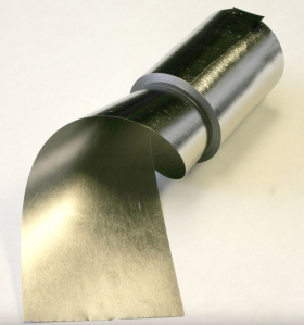 Close view of a roll soft metal gently unwinding.