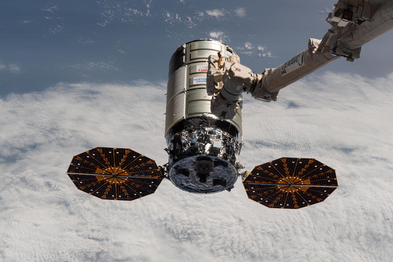 Northrop Grumman’s Cygnus space freighter approaches the International Space Station where the Canadarm2 robotic arm is poised t
