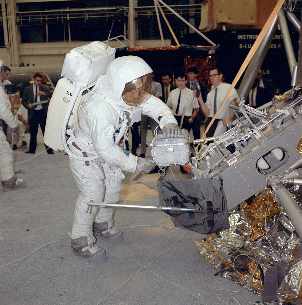 Apollo 11 commander Neil Armstrong works with an Apollo Lunar Sample Return Container