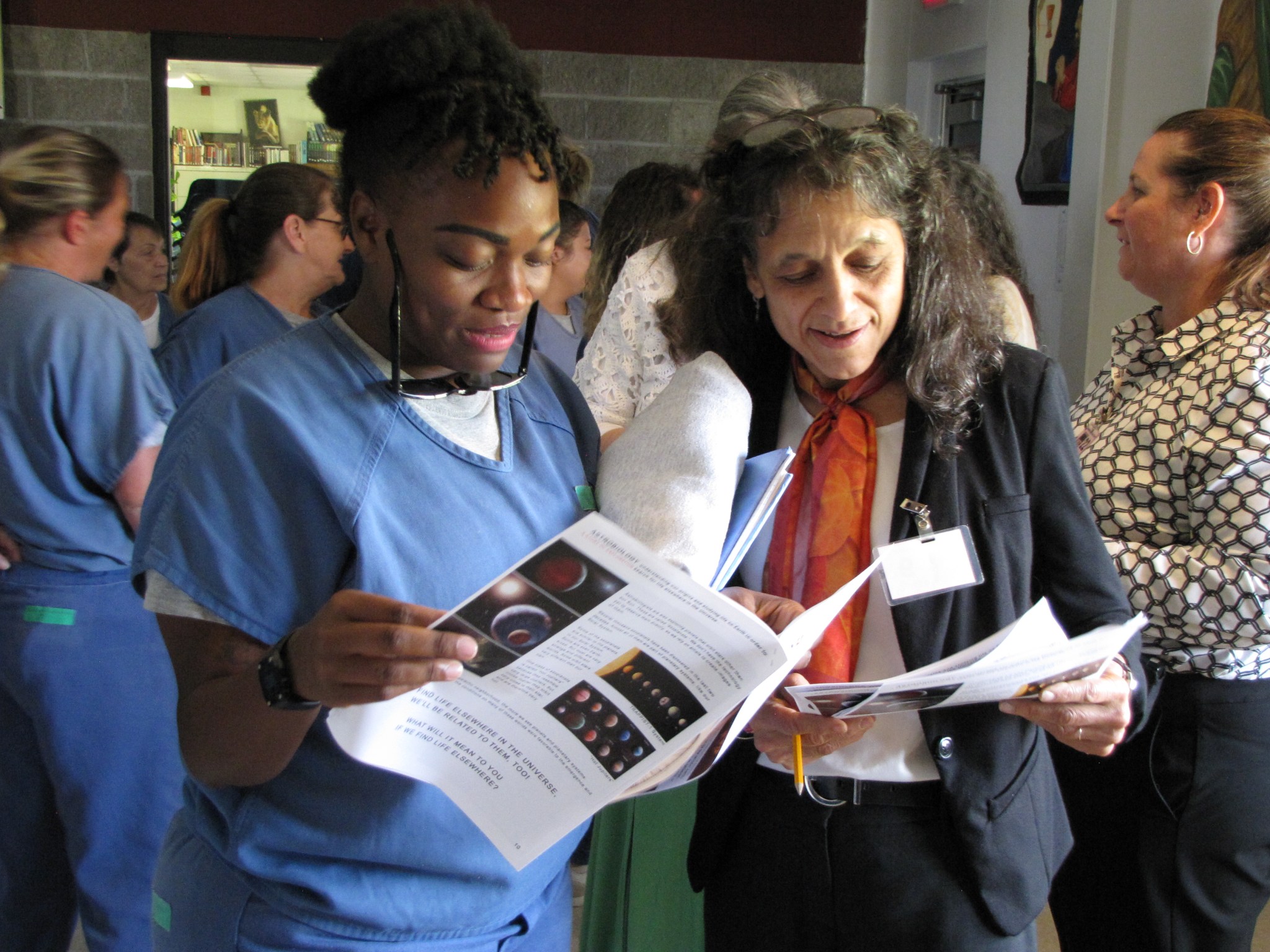 Two people looking over educational materials together.