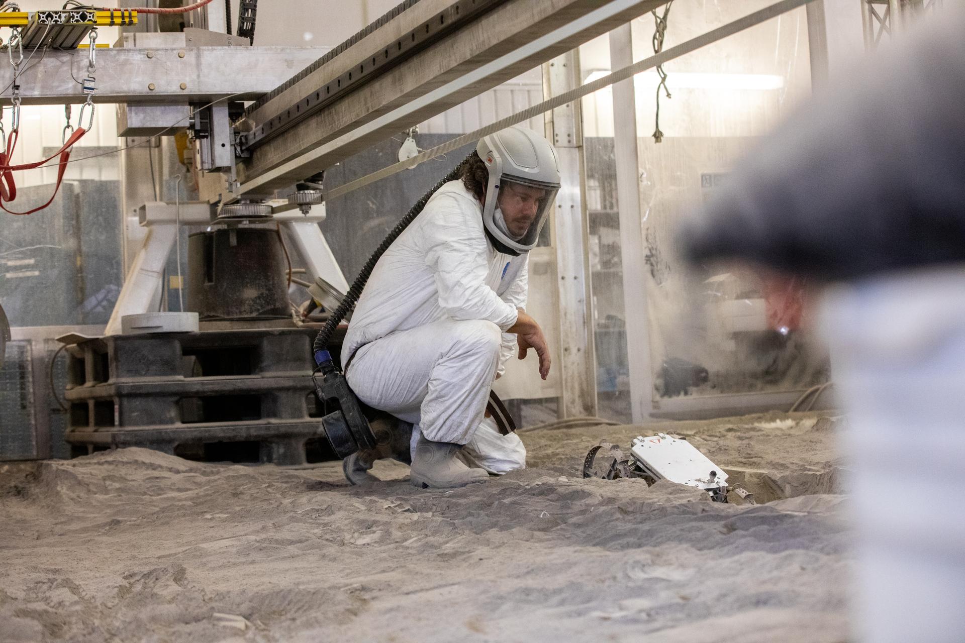 A.J. Nick with Kennedy's Exploration Research and Technology programs, checks the CubeRover in the regolith bin on Dec. 10, 2020