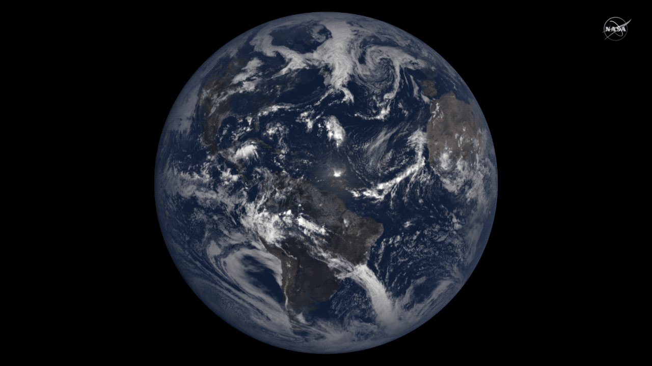 A series of satellite images of Earth show the Earth rotating and a dark oval-shaped shadow moving over North America from left (west) to right (east).