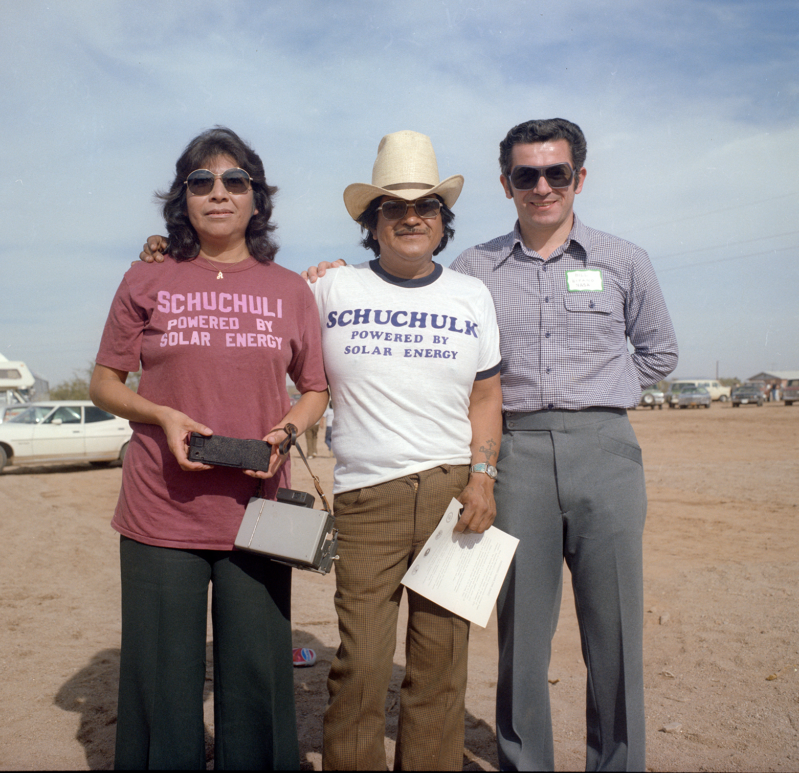 Two Native Americans pose for photograph with NASA engineer.