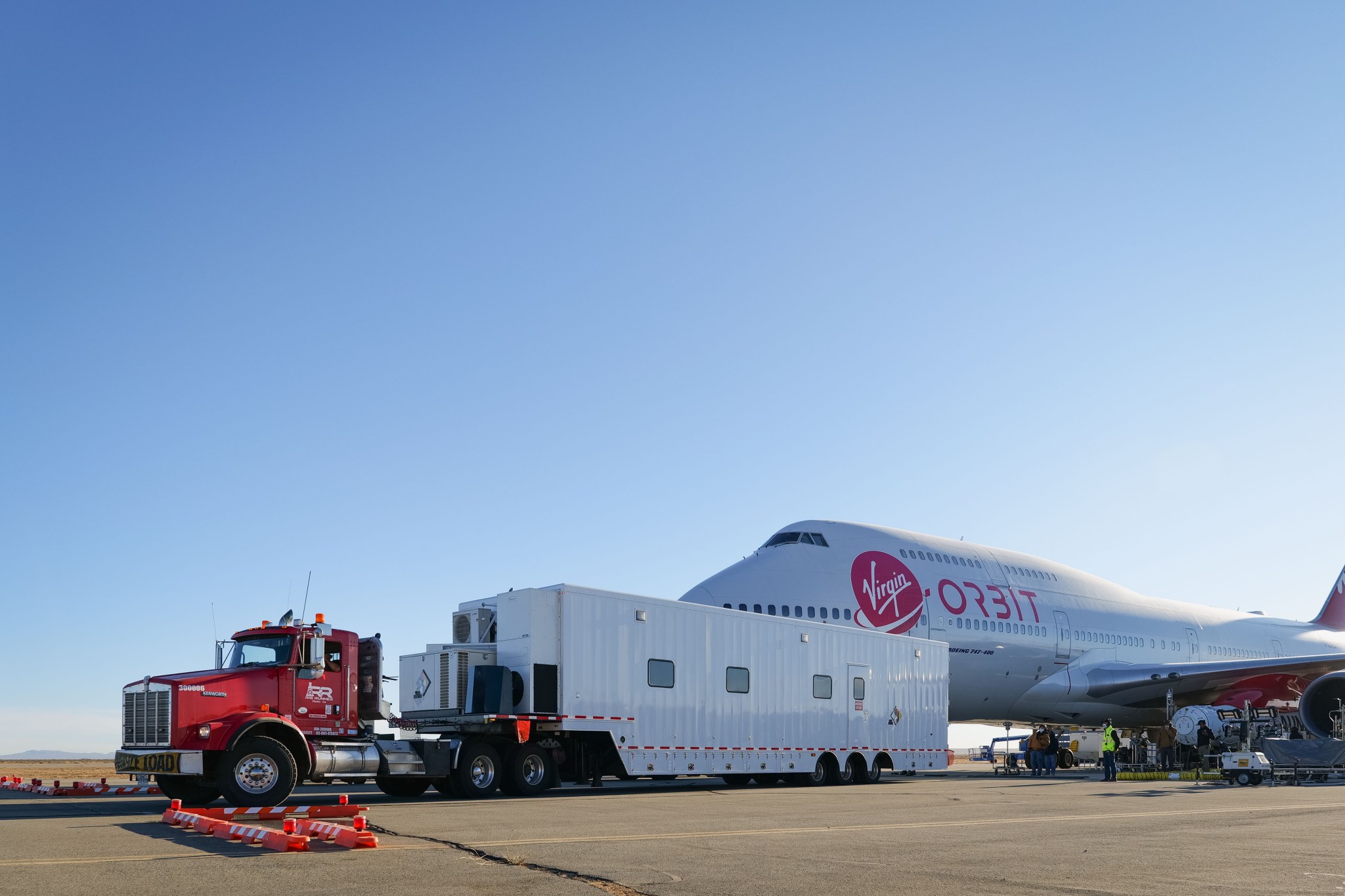 Virgin Orbit's payload trailer, carrying several NASA-sponsored small satellites, arrives at the Mojave Air and Space Port.
