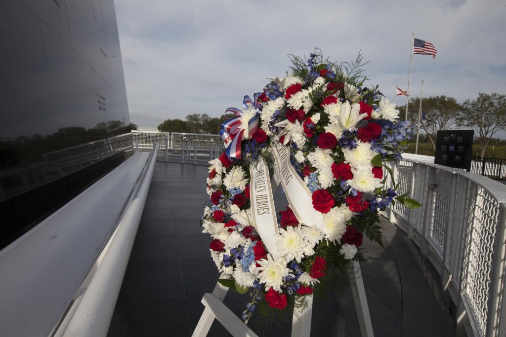 Image shows wreath at Kennedy Space Center marking lives lost during space missions.