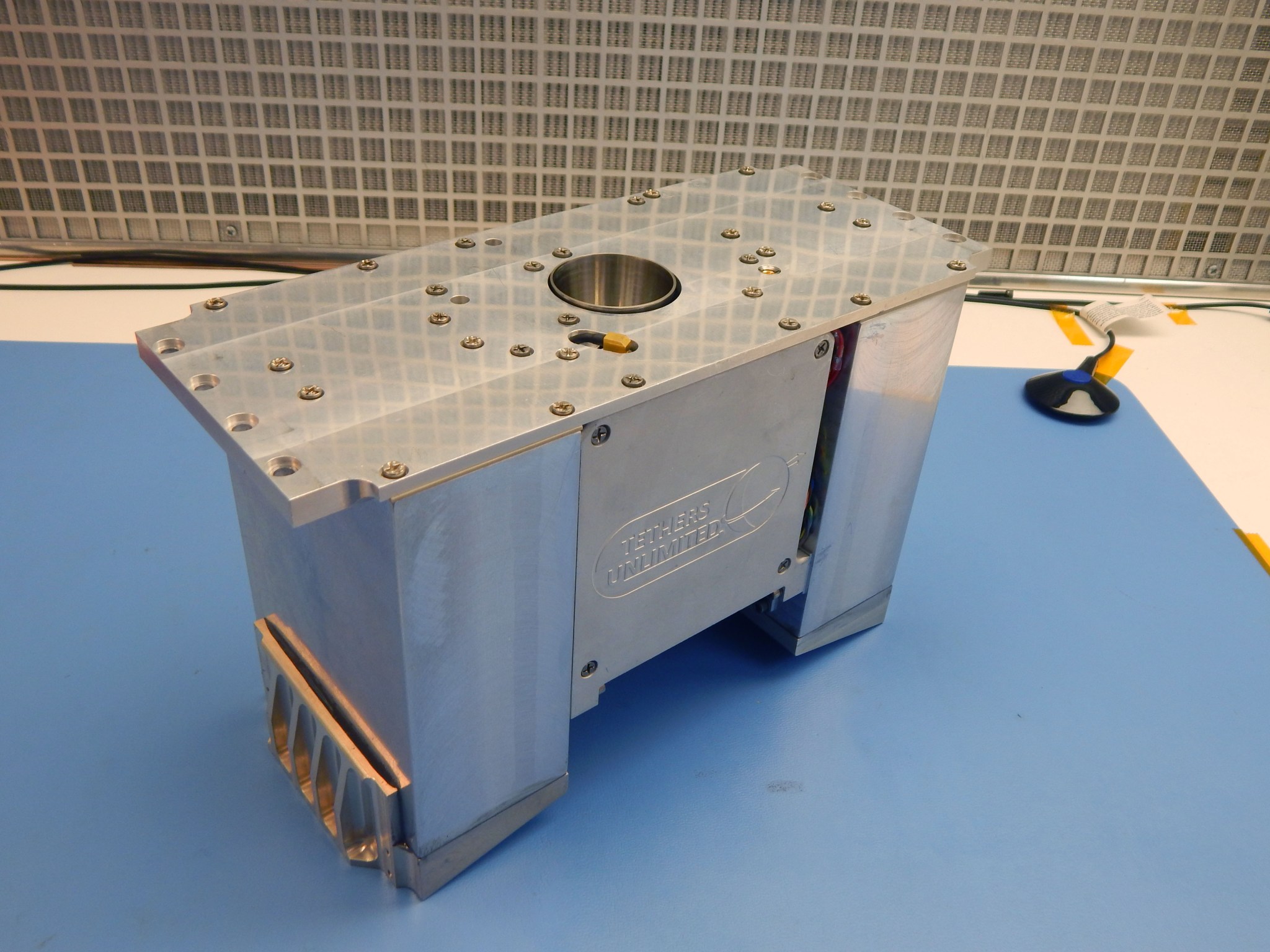 A small metal unit on a white table.