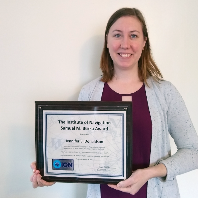 In this photo, GPS ACE engineer Jennifer Donaldson holds the Institute of Navigation's Samuel M. Burka award.
