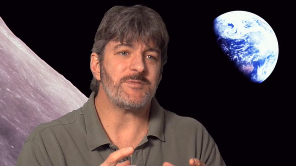 man in front of image of moon, Earthrise