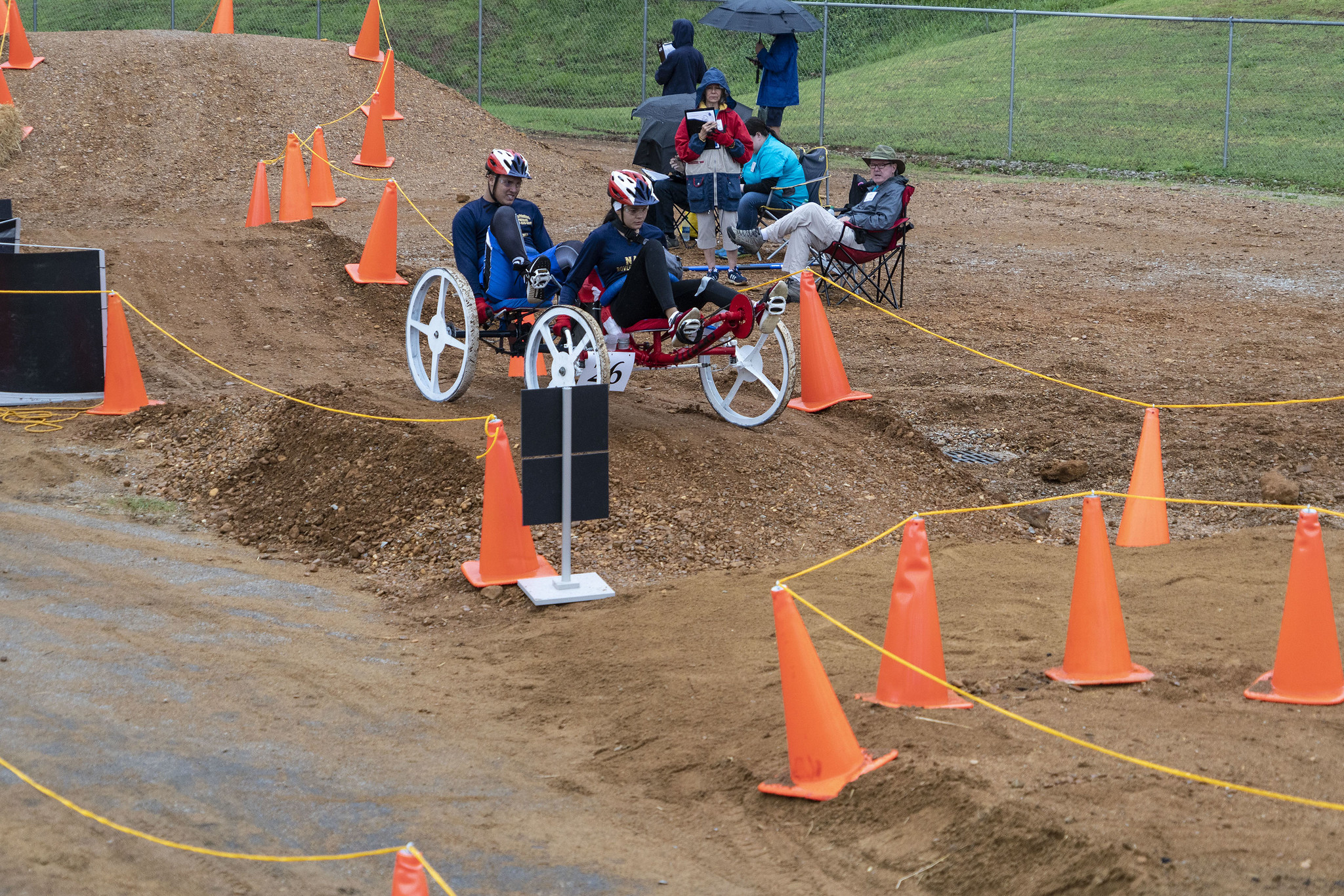 Two students on a human-powered rover on simulated Martian terrain