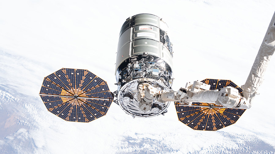 The Cygnus space freighter is pictured in the grips of the Canadarm2 robotic arm in February of 2020 during Expedition 62.