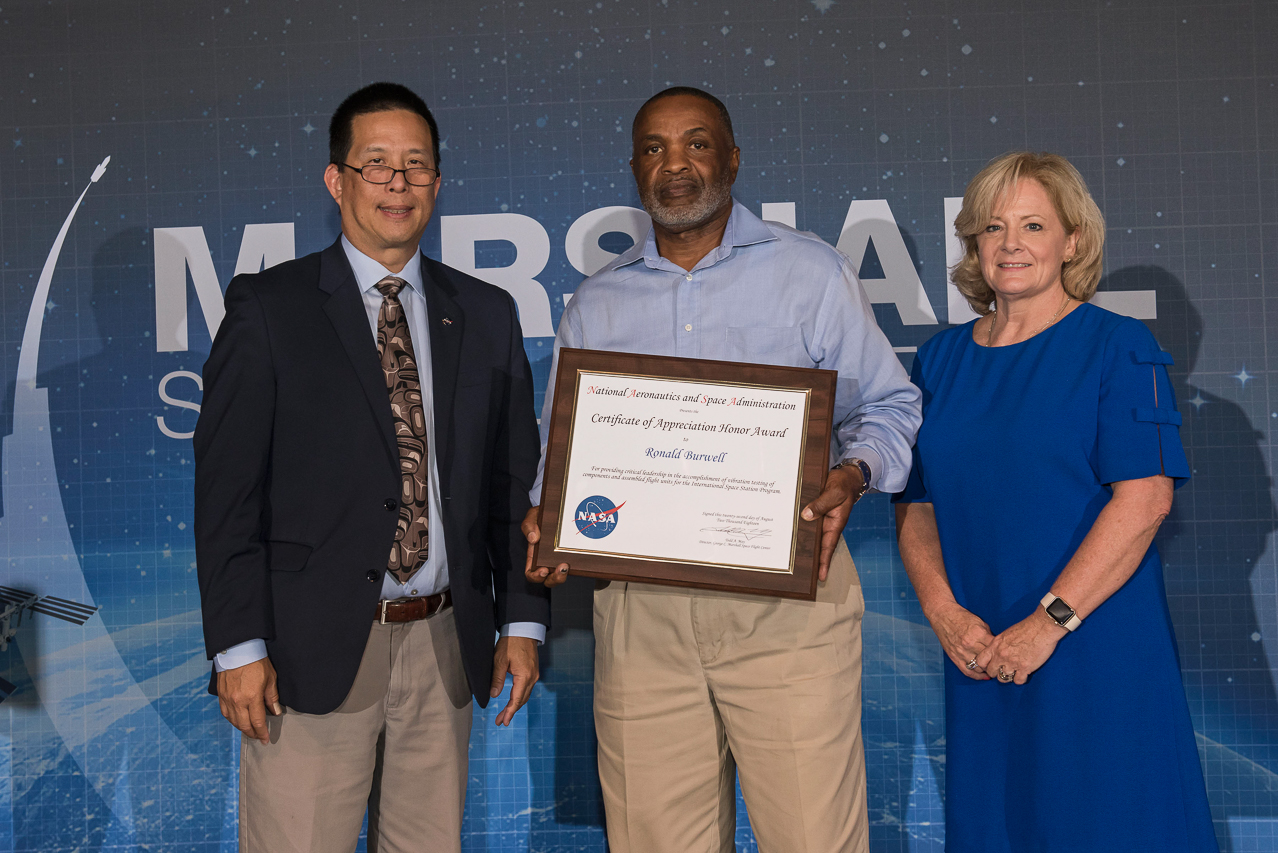 Ron Burwell, center, receives a Marshall Certificate of Appreciation Honor Award in 2018 from Eugene Tu, left.