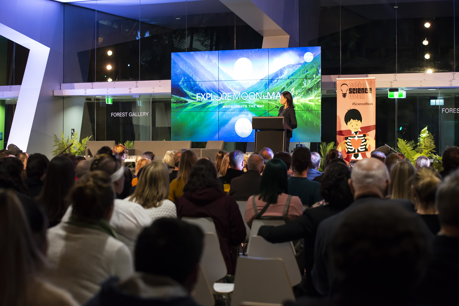 NASA astrobiolist Darlene Lim delivers a keynote speak to a large audience at a conference.