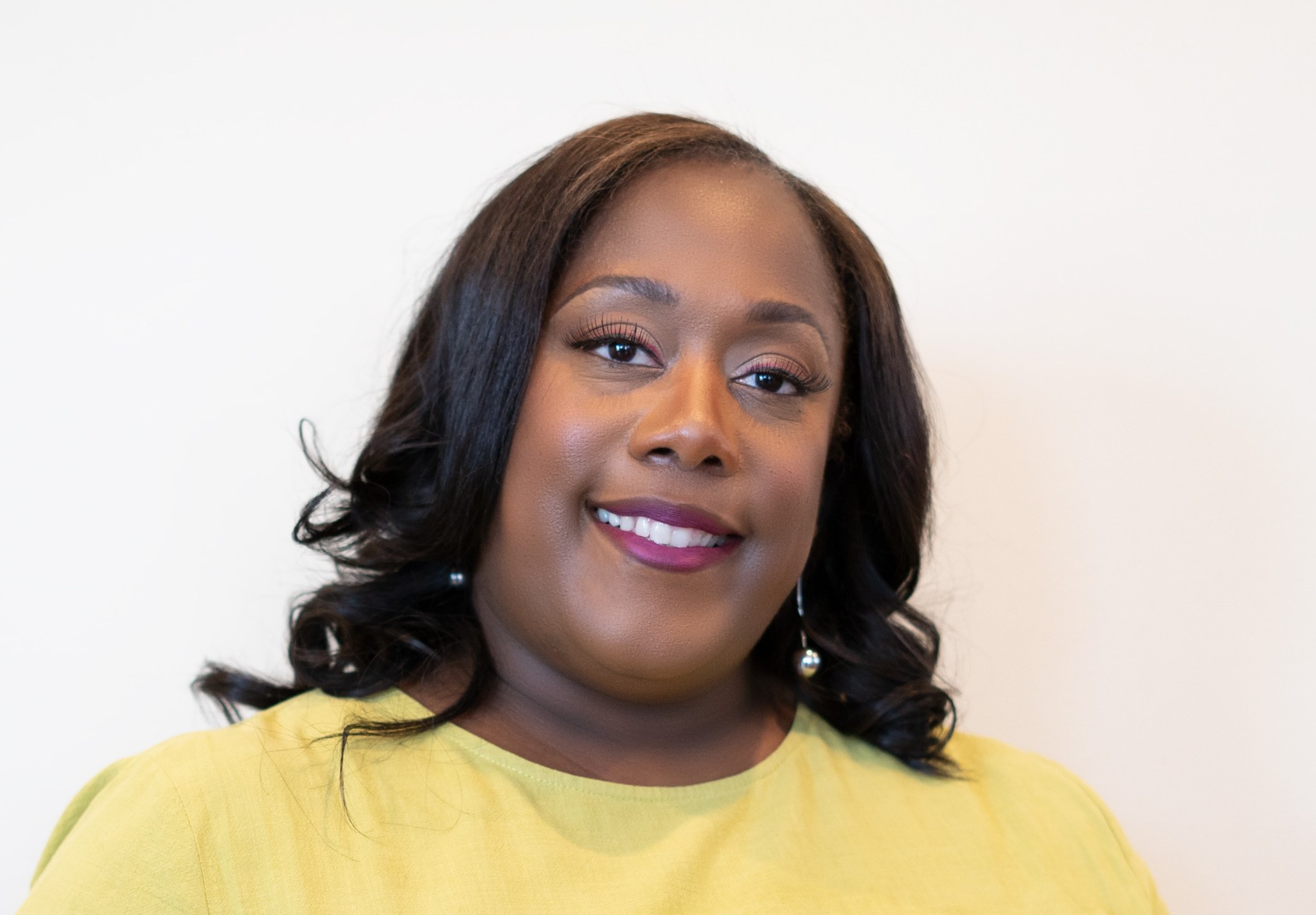 headshot of Michelle Jones, she is wearing a yellow shirt against a white background