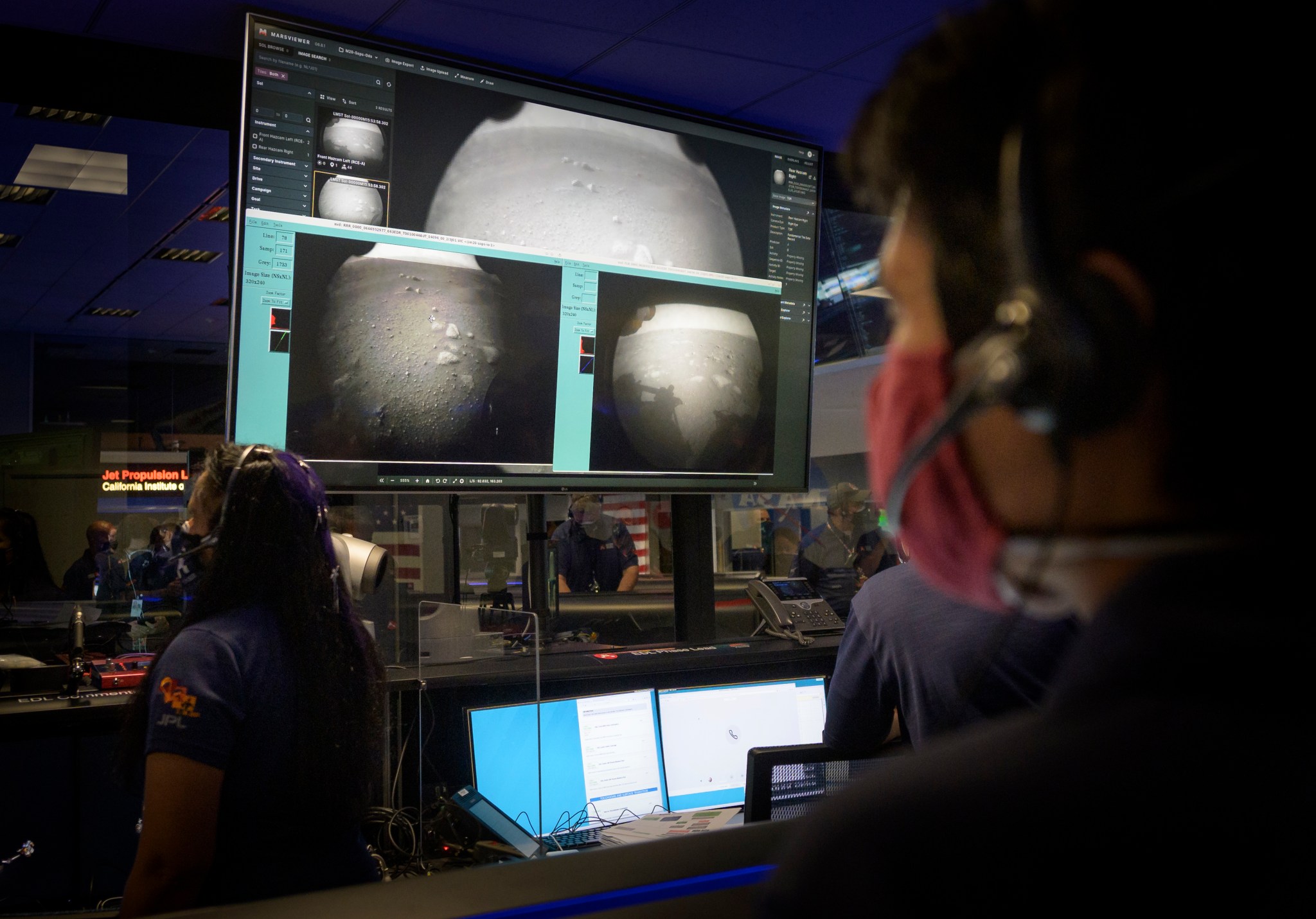 Members of NASA’s Perseverance Mars rover team watch in mission control as the first images arrive