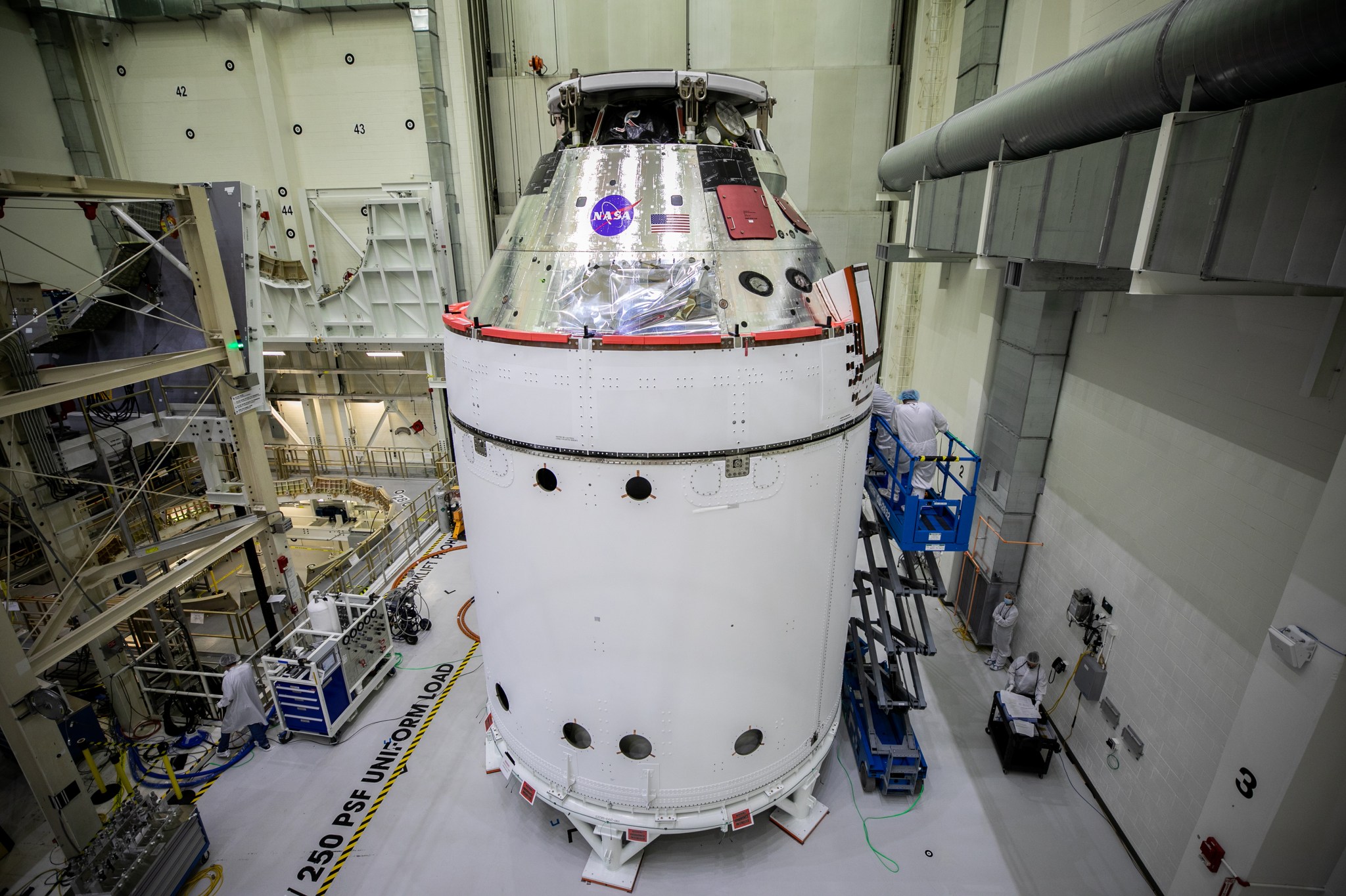 The Orion spacecraft for NASA’s Artemis I mission is in view inside the Neil Armstrong Operations and Checkout Building