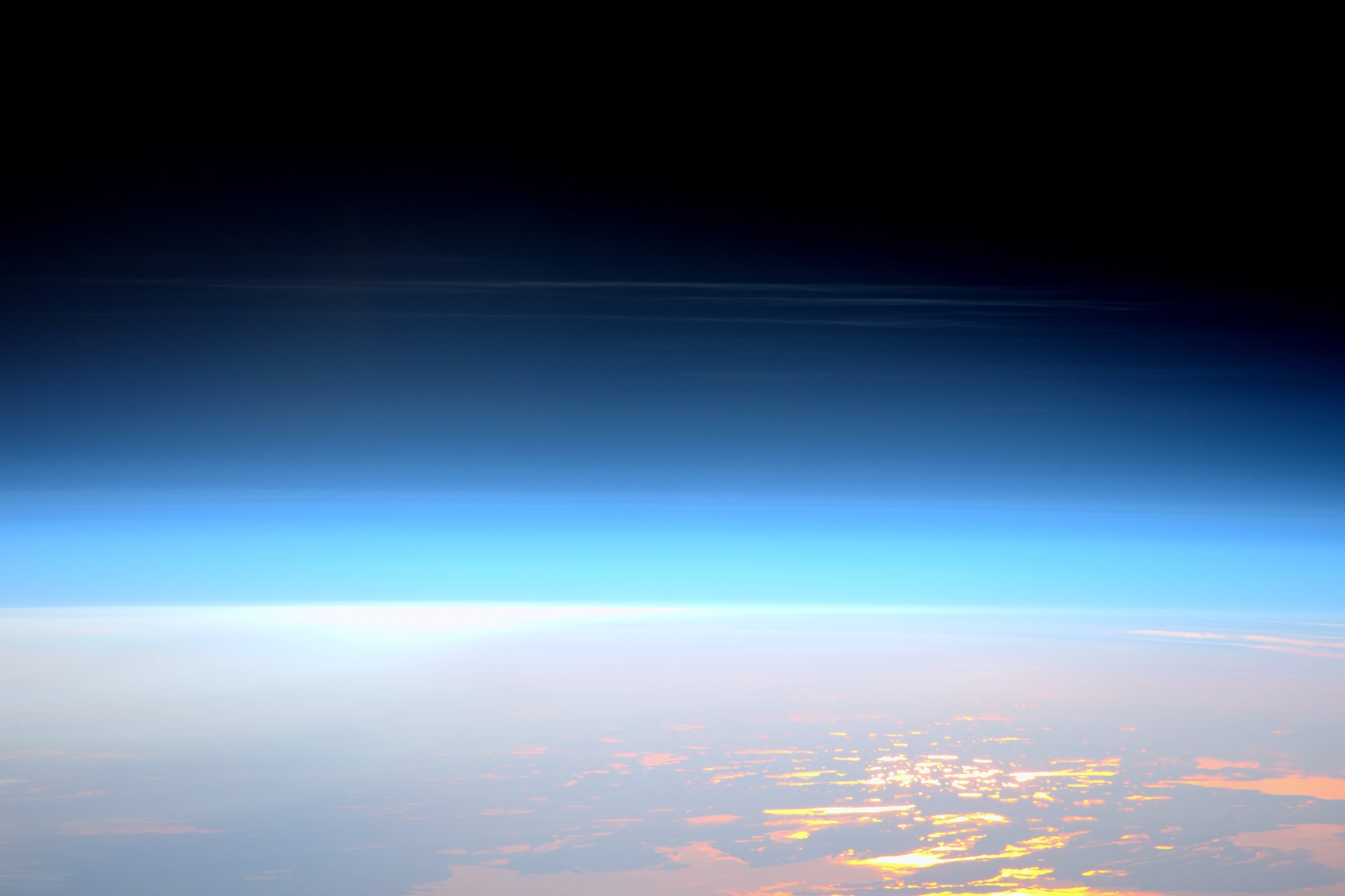 A rare high altitude noctilucent clouds as viewed from the International Space Station.