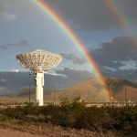 A double rainbow arcs above a Near Space Network antenna pointed to the sky.