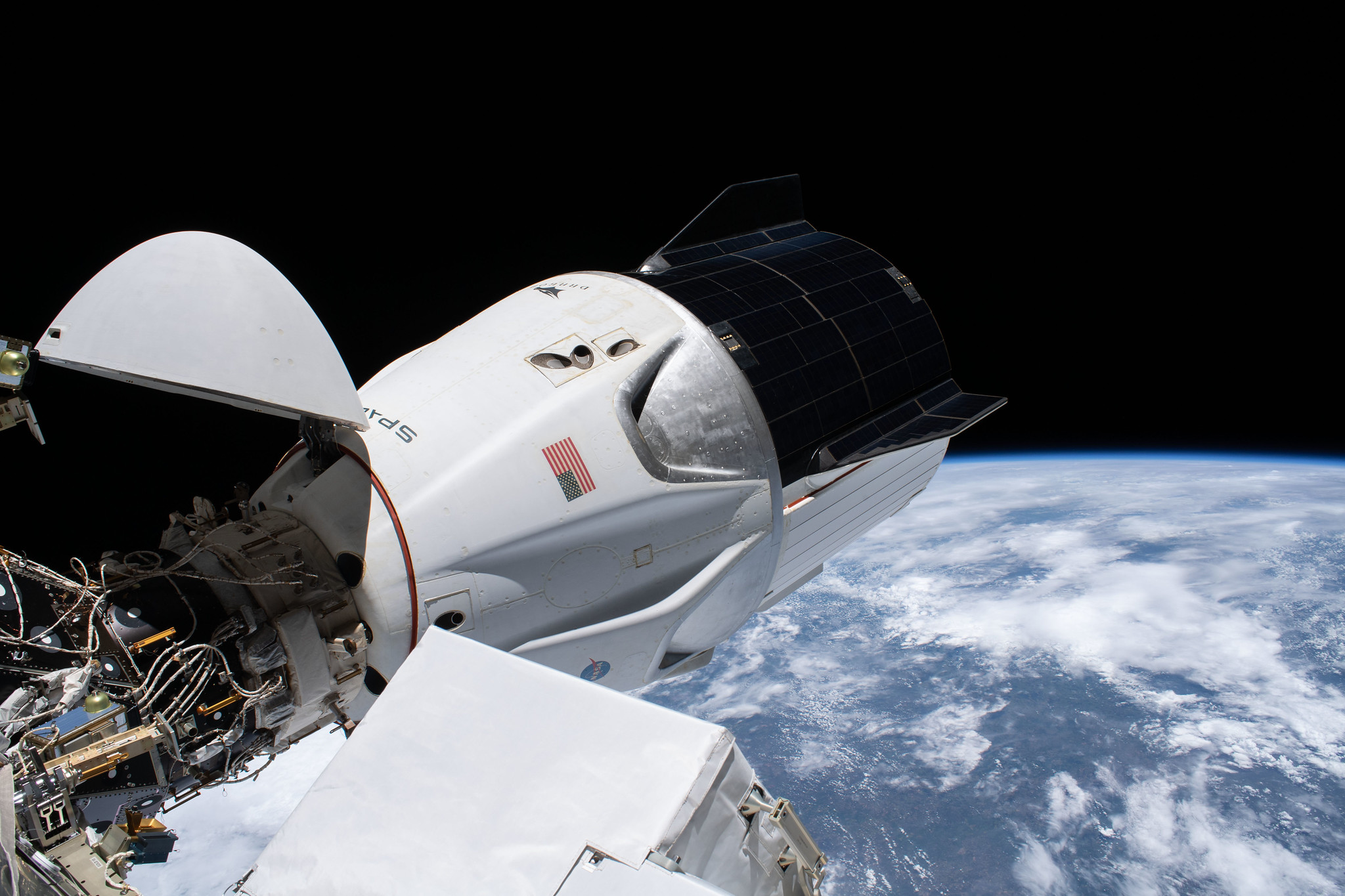 The SpaceX Crew Dragon spacecraft is pictured docked to the Harmony module's forward international docking adapter