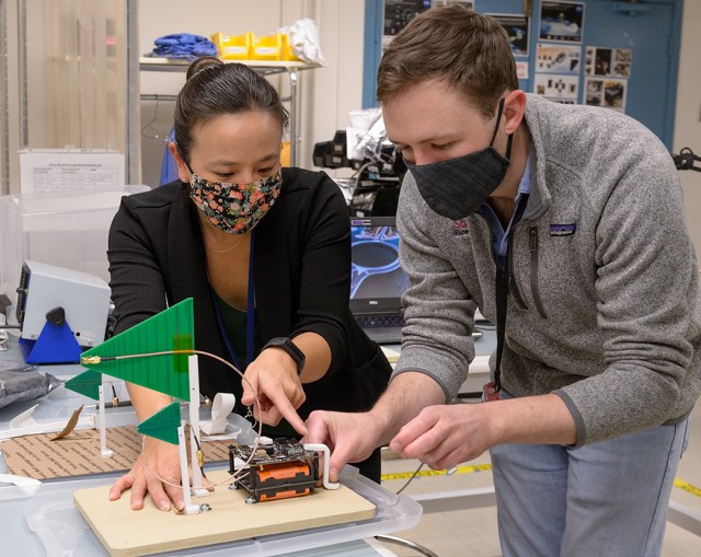 Anh Nguyen, project manager for the V-R3x mission, left, and Max Holliday of Stanford University, center