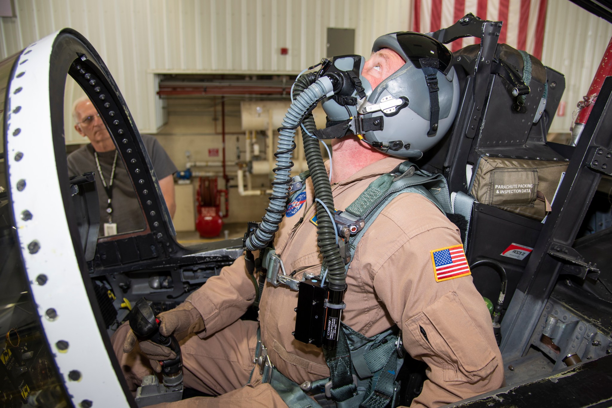 NASA pilot Jim Less is assisted by life support as he is fitted with a Cobham designed VigiLOX pilot oxygen monitoring system.