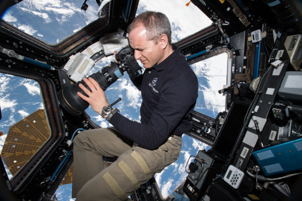 astronaut David Saint-Jacques taking photos of earth from the space station