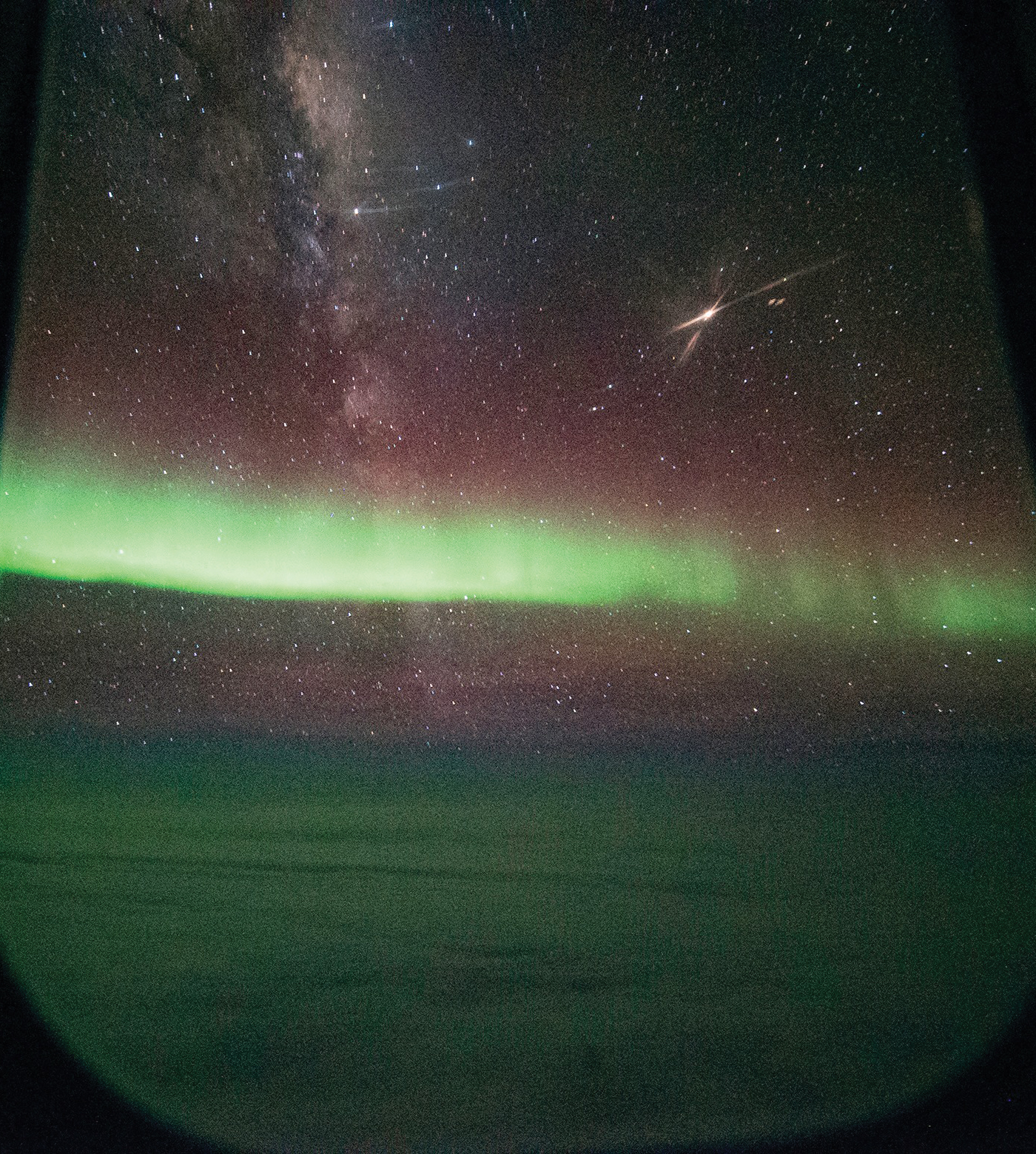 Aurora glow green with Milky Way and Mars shine brightly above it.