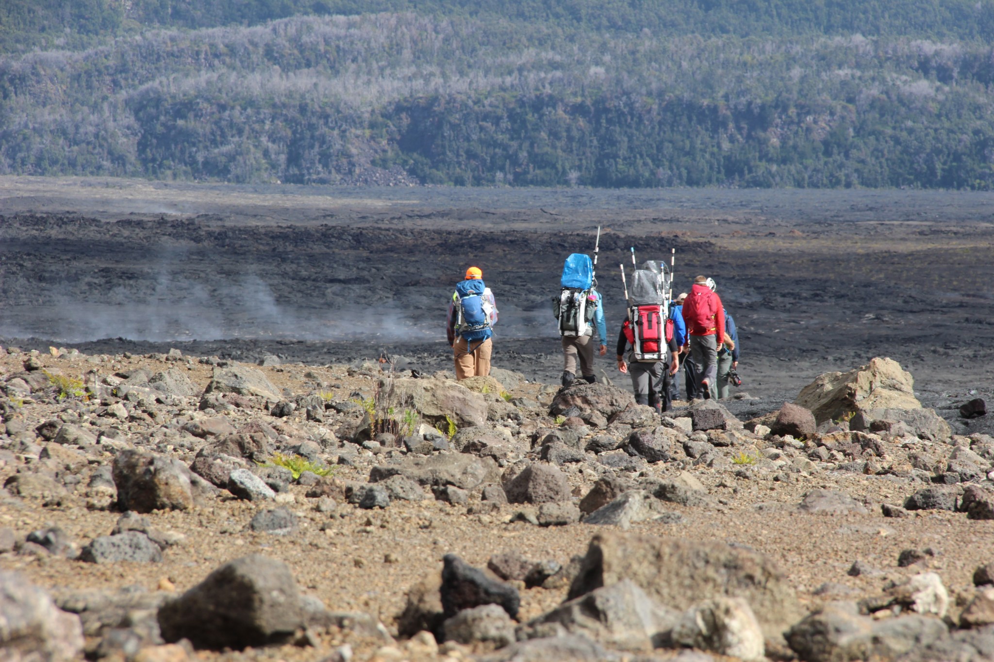 A team sets off across the lava field near Keanakakoi crater on Hawaiis Kilauea volcano.