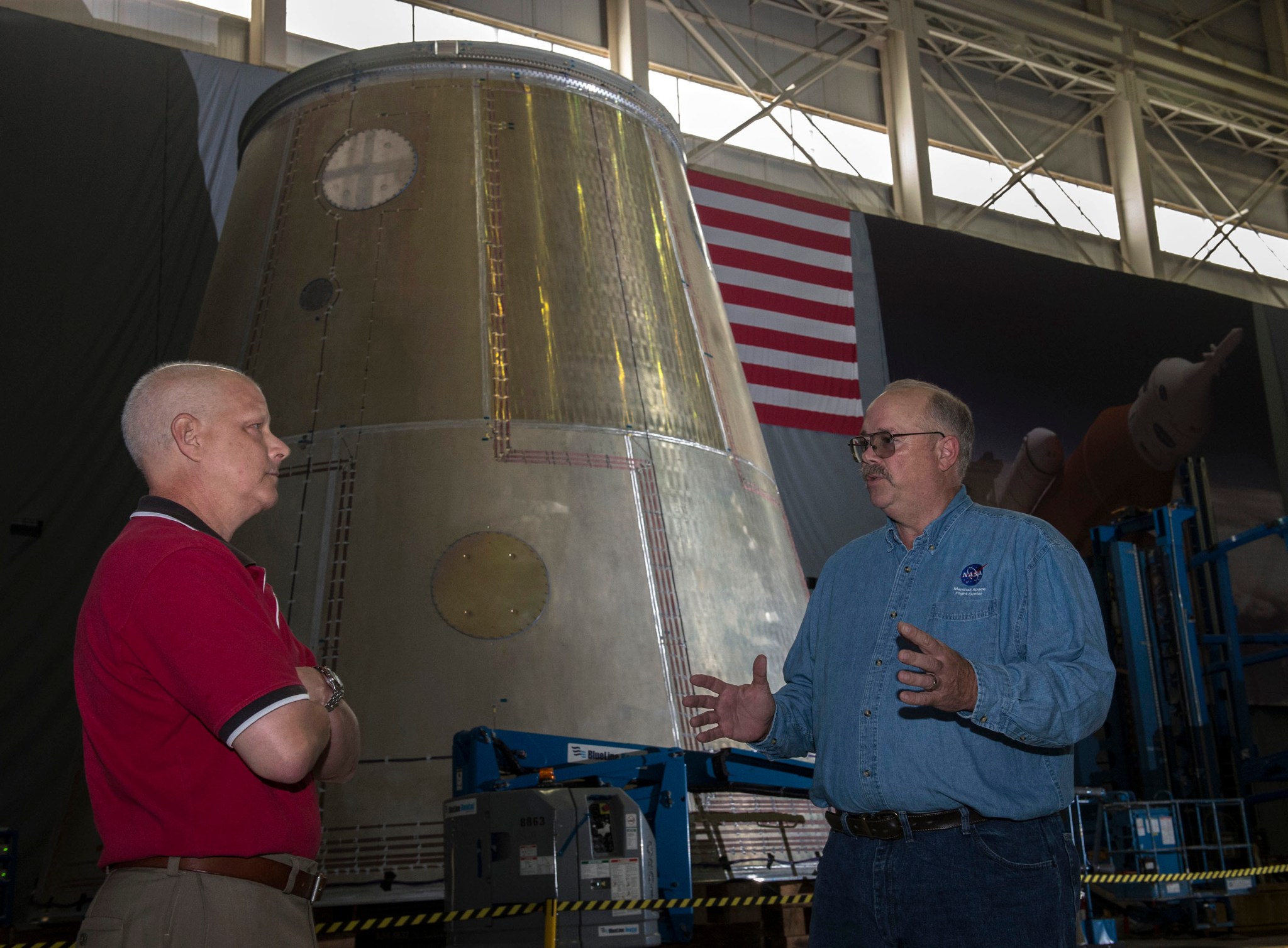 In 2016, Rick Burt, right, and Andy Schorr discuss fabrication of the Space Launch System Vehicle Stage Adapter.
