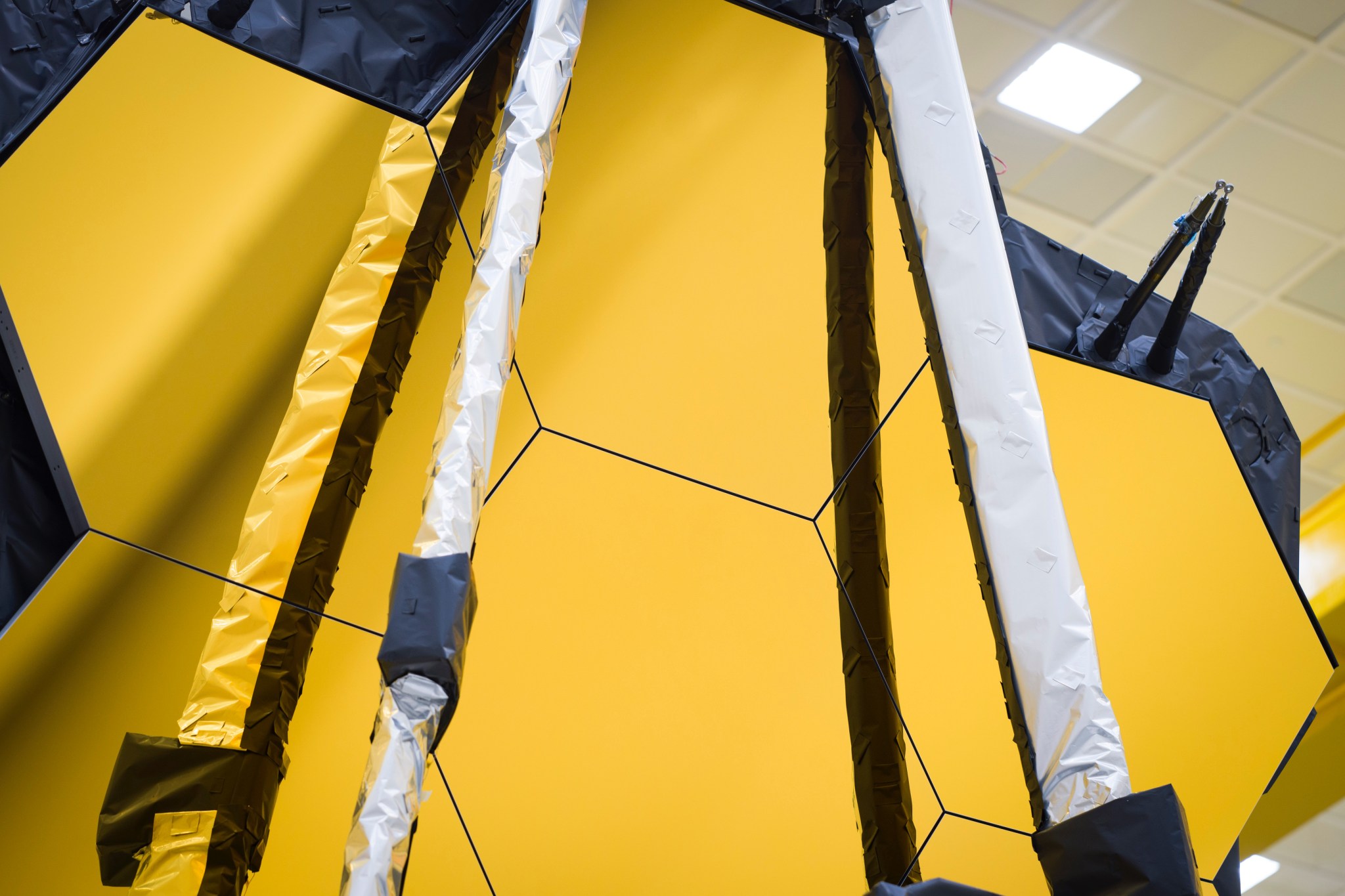 Close-up of six golden octagonal mirrors of the James Webb Space Telescope.